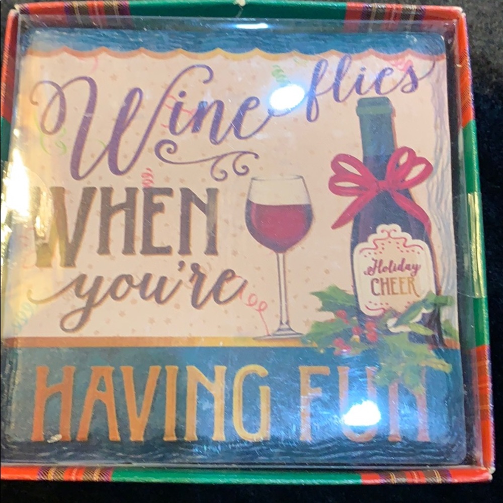 FREE WITH $50 purchase. Set of four coasters. Wine flies... having fun NH3